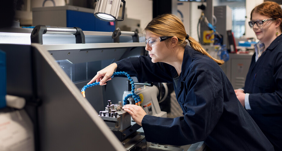 Two engineering students working in a mechanics lab
