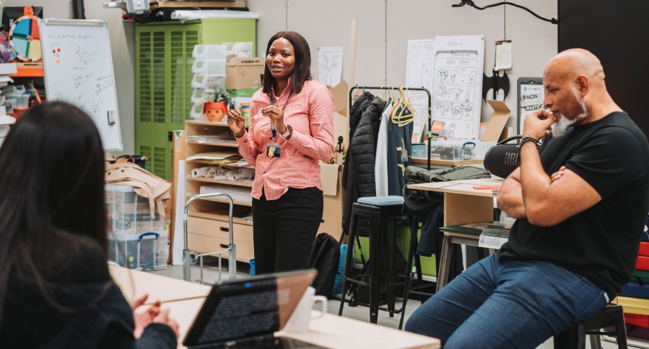 In a classroom, a speaker addresses a group during an MBA workshop.