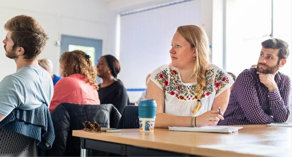 Group of students sitting and listening to a conference session