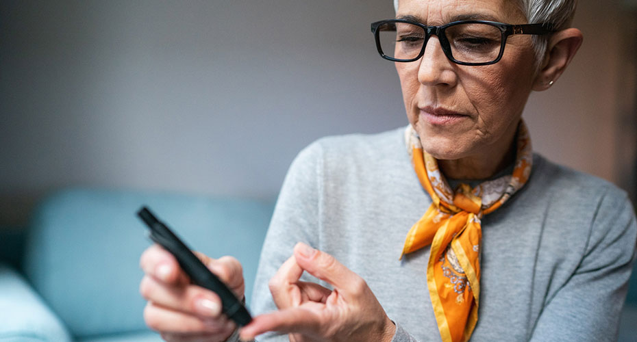 A person uses a finger prick test to determine blood sugar glucose levels. Insulin, diabetes.