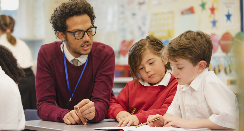 Male teacher with two primary children