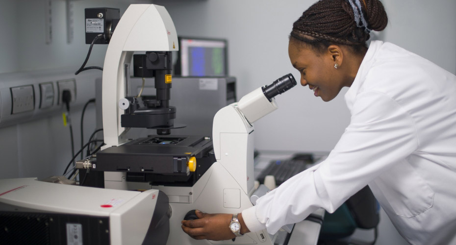 Lady in white lab coat using equipment