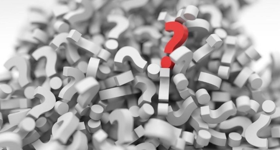 A collection of 3D question marks, all white except for one which is red