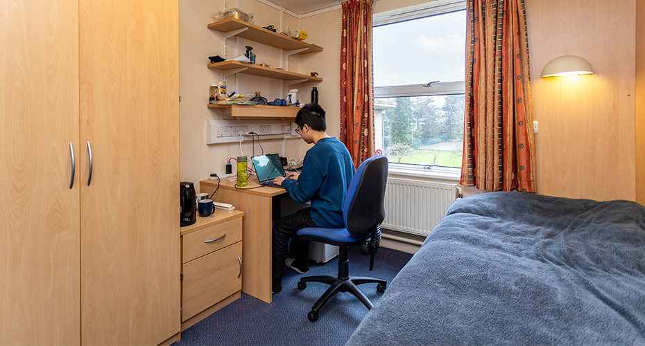 A student studying in a single bedroom in Ransom Pickard