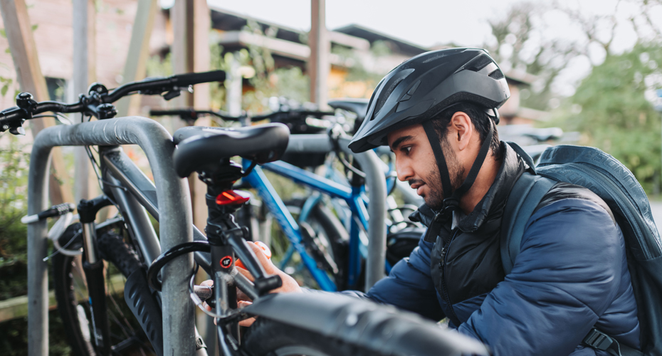 Student securing bike to bike rack