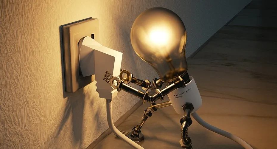A robot connected to an electrical outlet, featuring a lit light bulb, representing energy and technological advancement.