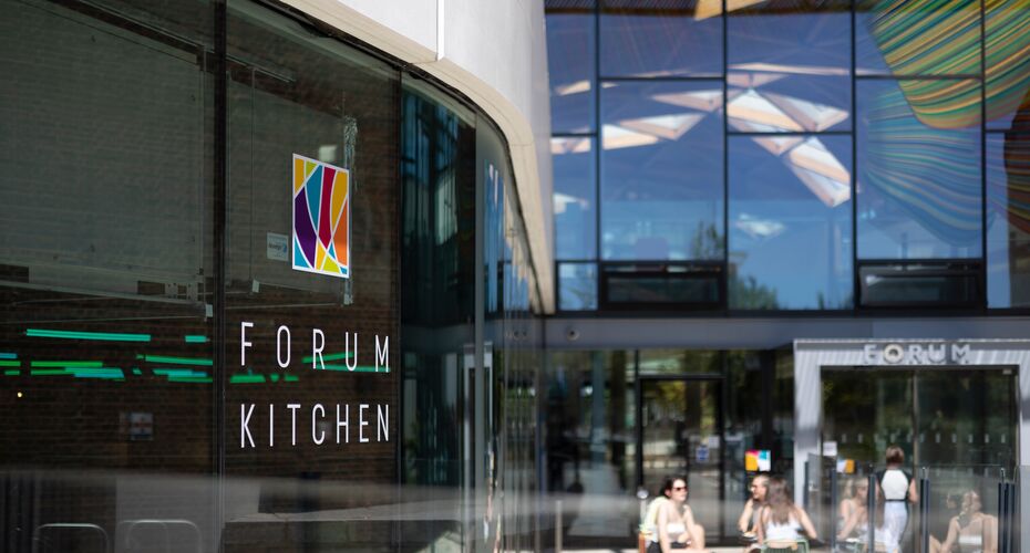 The outside window of the Forum Kitchen, displaying the Forum Kitchen Logo