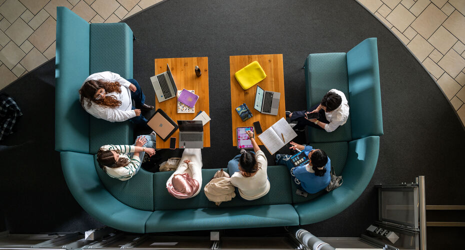Group of students studying at laptops