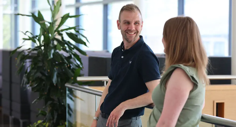 Two staff talking